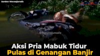 VIDEO: Aksi Pria Mabuk Tidur Pulas di Genangan Banjir