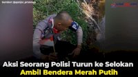VIDEO: Aksi Seorang Polisi Turun ke Selokan Ambil Bendera Merah Putih