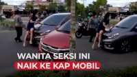 VIDEO: Heboh, Wanita Berpakaian Seksi Naik ke Kap Mobil yang Melaju