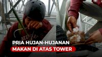 VIDEO: Pria Hujan-hujanan Makan di Atas Tower Bikin Netizen Syok
