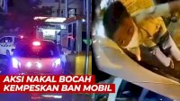 VIDEO:Aksi Nakal Bocah Kempeskan Ban Mobil yang Keluar dari Parkiran Megamas Manado