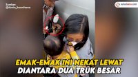 VIDEO: Waduh, Emak-emak Gendong Anak Nekat Lewat Diantara Dua Truk besar