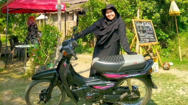Salmia yang menggunakan motor Honda Astrea saat bekerja di Rumah Hijau Denassa. Foto: Dokumen pribadi Salmia. 