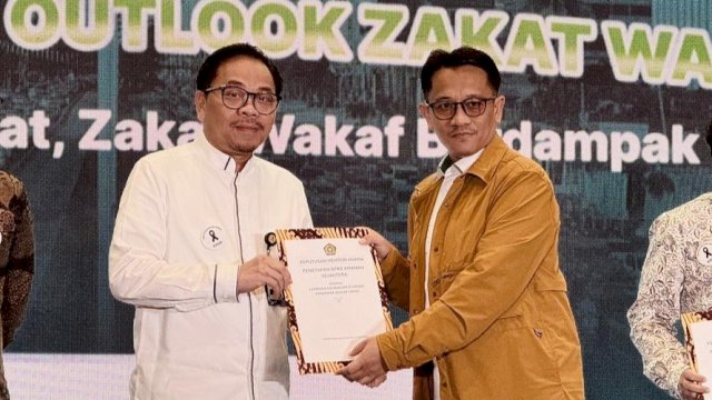 Direktur Pemasaran &amp; Syariah Bank Sulselbar Dirhamsyah Kadir saat menerima surat keputusan LKS PWU. Foto: Istimewa.